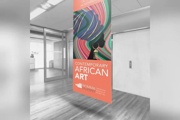 Canvas banner with art hanging in a gallery