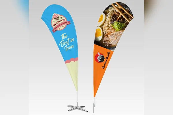 Two custom teardrop flags on cross bases